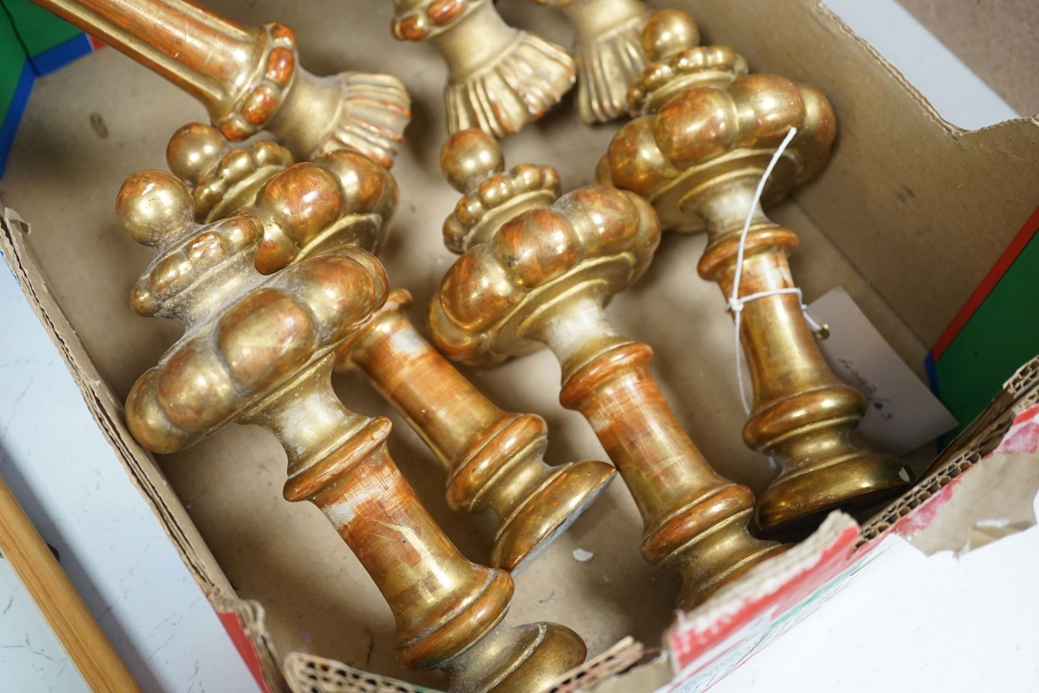 Two sets of four giltwood curtain tie/hold backs, Longest 31 cms.